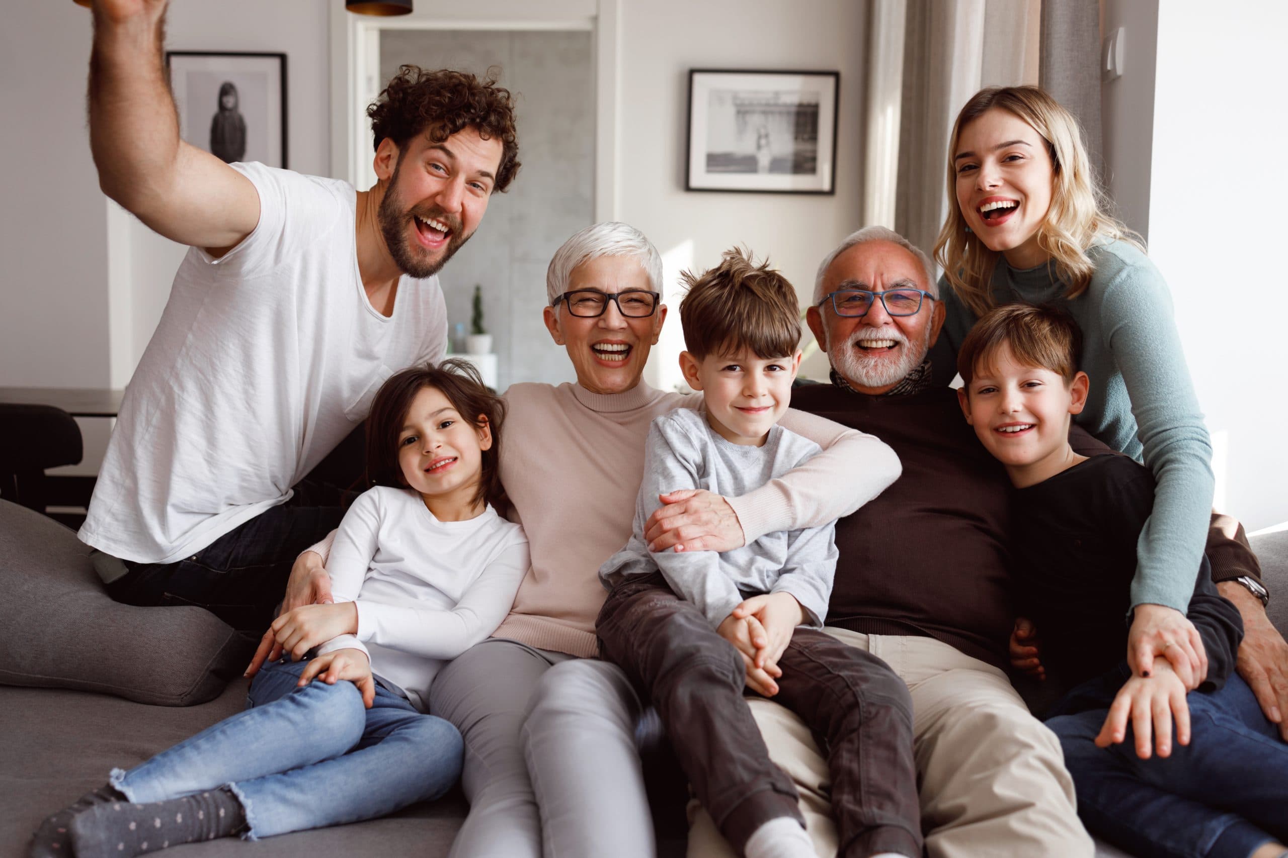 A multigenerational family smiling together at home