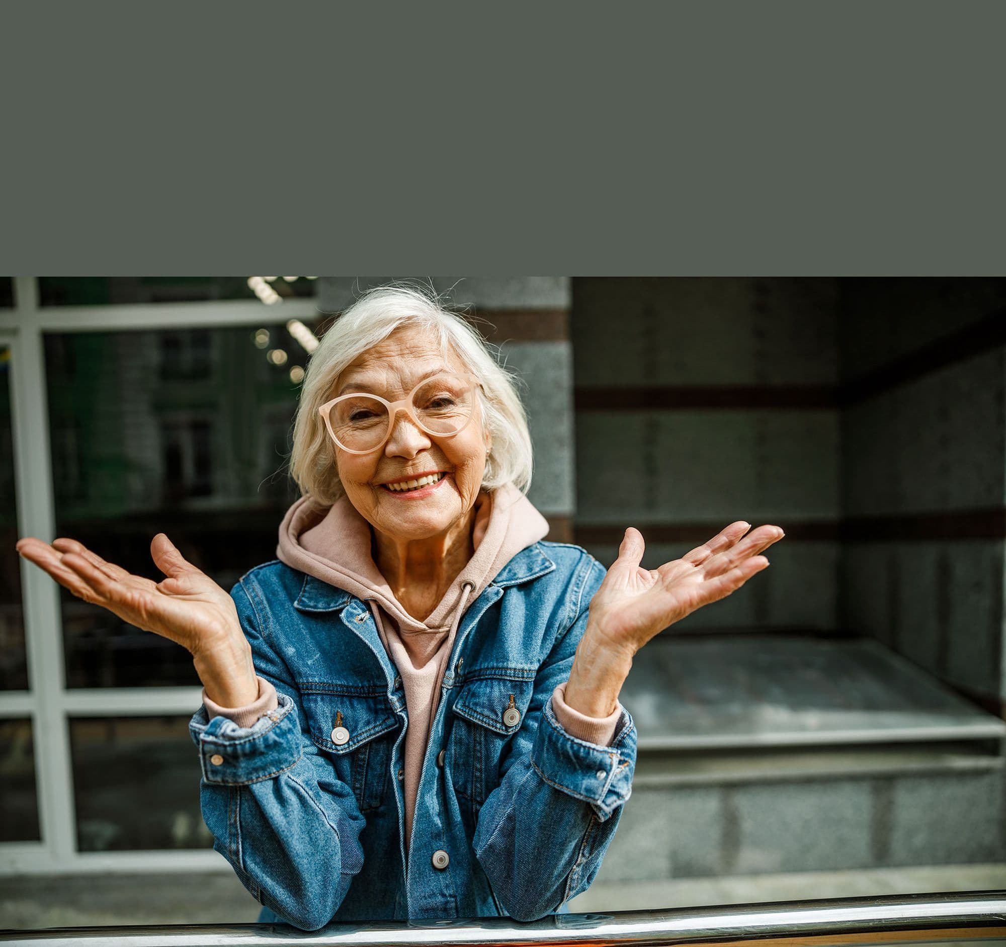 A smiling senior woman shrugging good-naturedly