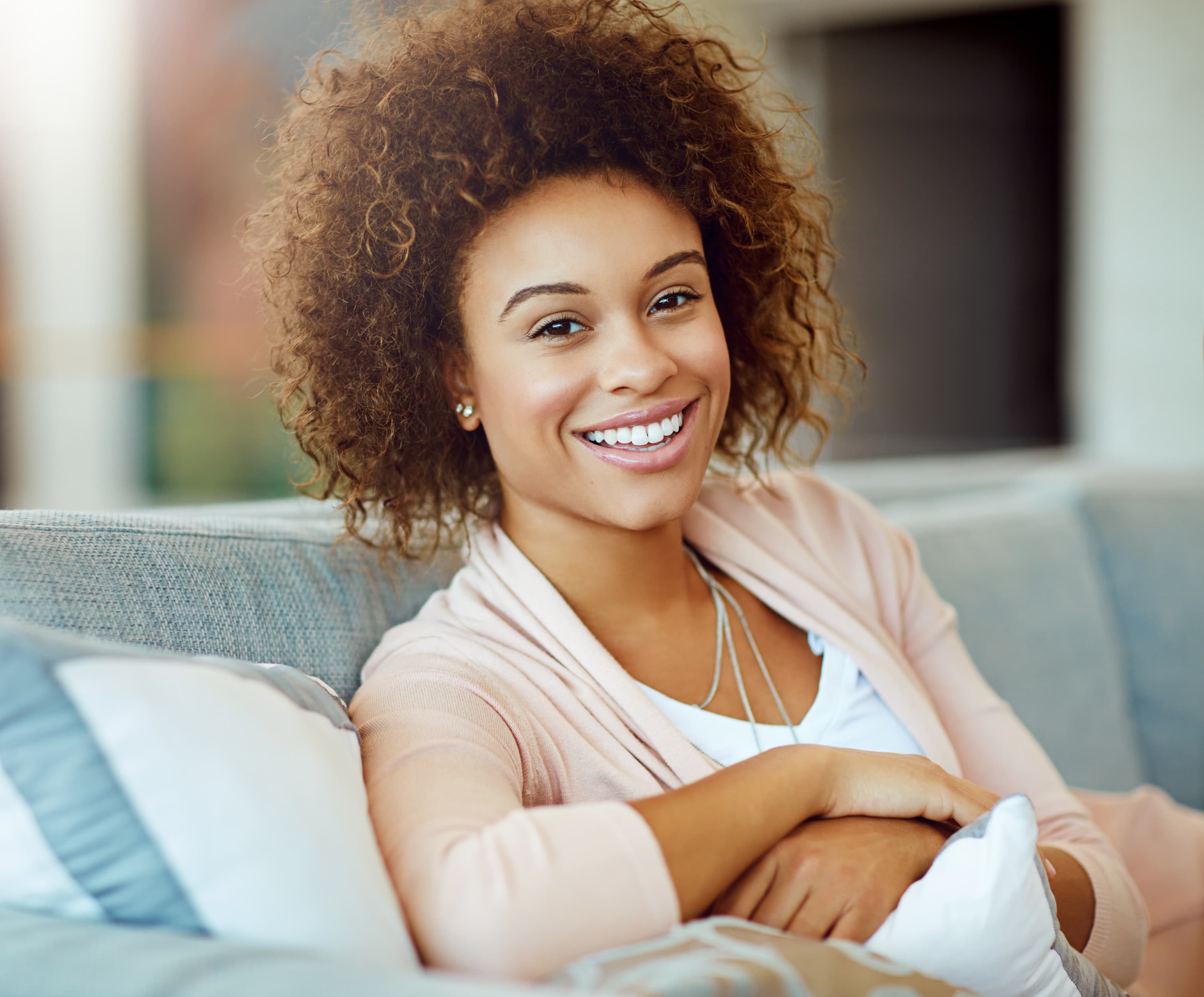 A relaxed, confident patient smiling comfortably at home