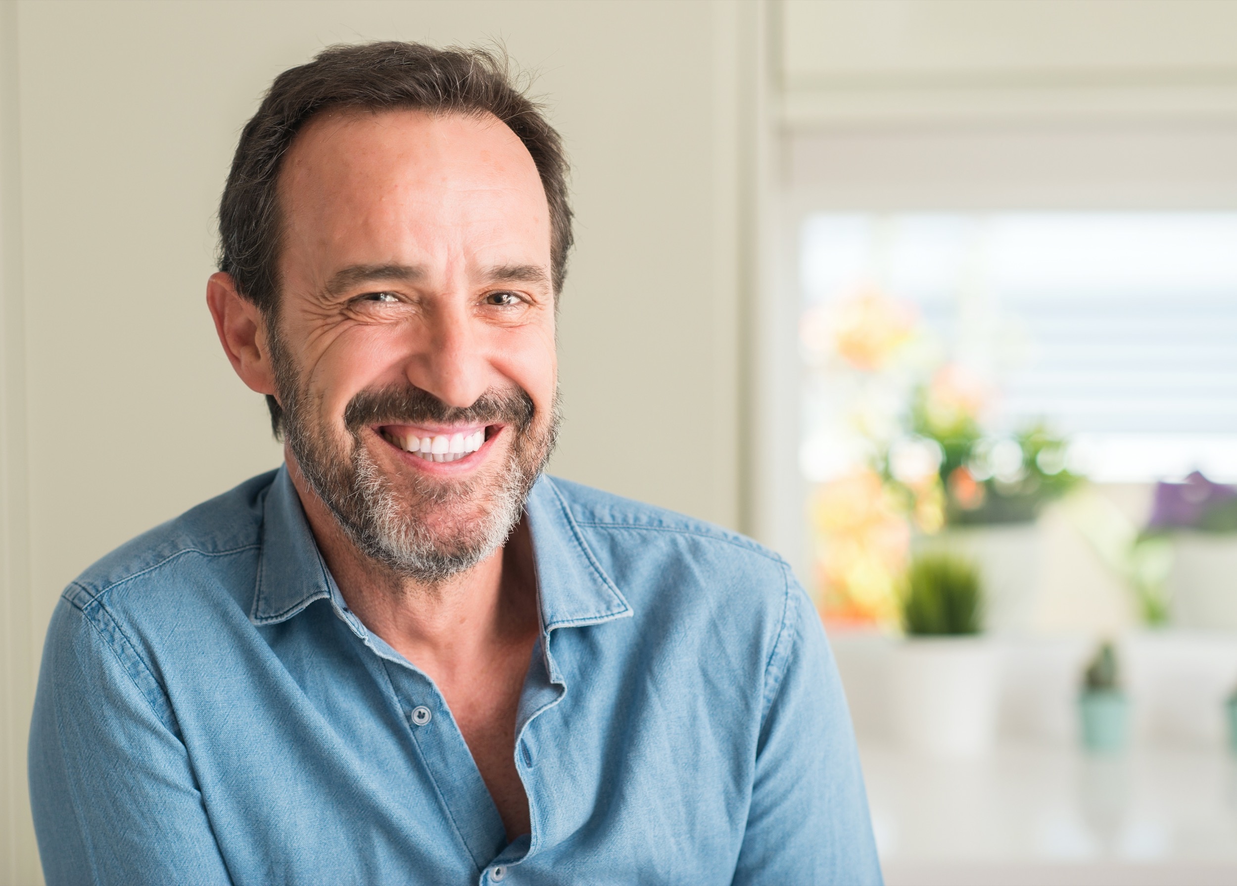 A smiling patient with a full, natural-looking smile