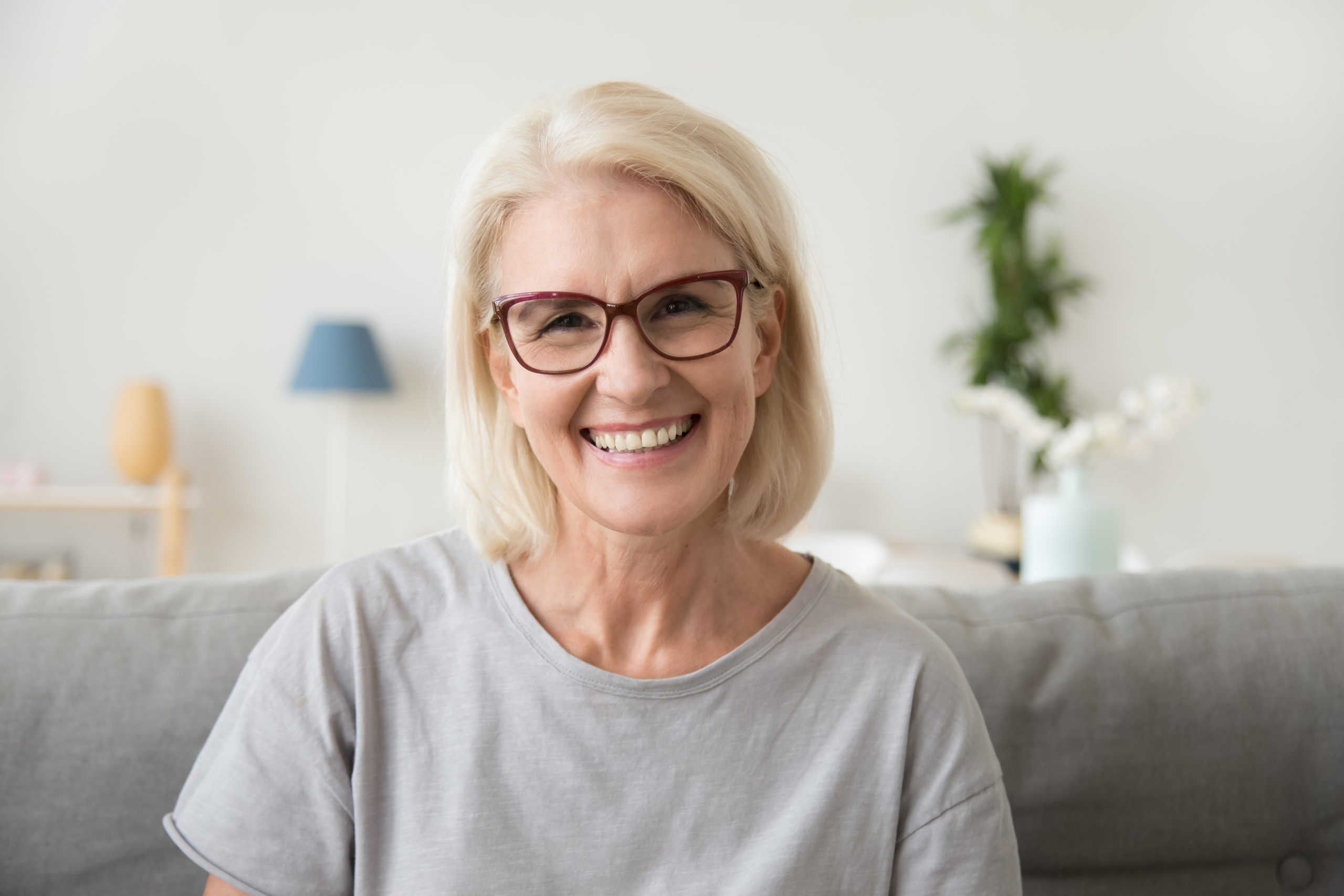 A smiling senior patient with a natural denture fit